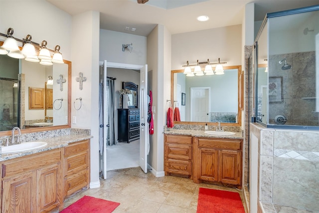 bathroom featuring tile patterned flooring, a shower with door, and vanity