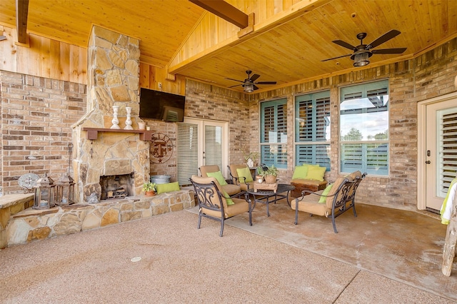 view of patio / terrace featuring an outdoor living space with a fireplace and ceiling fan