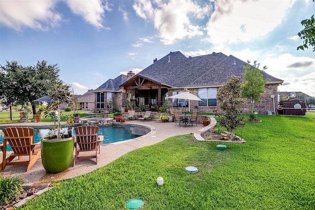 view of pool featuring a lawn and a patio area