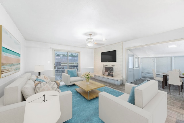 living room with a fireplace, hardwood / wood-style floors, and ceiling fan