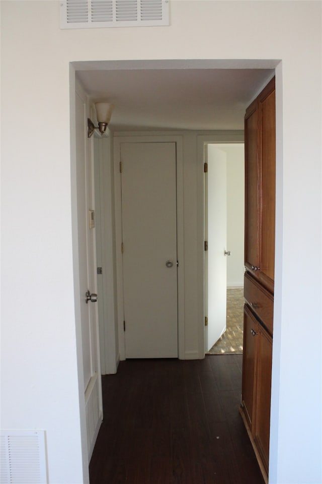 hallway with dark hardwood / wood-style floors