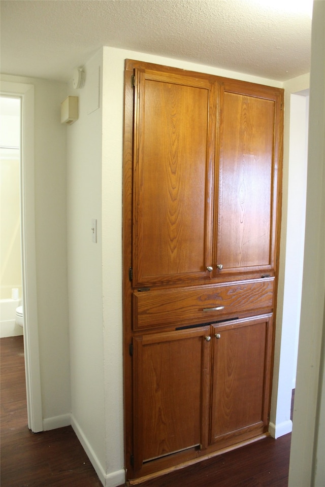 room details with a textured ceiling and hardwood / wood-style floors