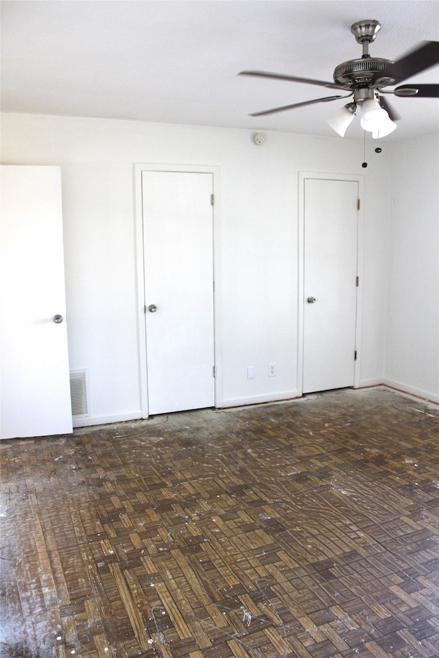 spare room with ceiling fan and dark wood-type flooring