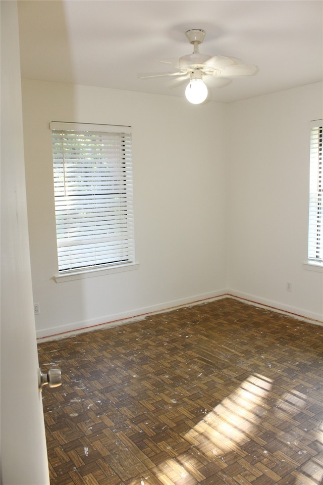 spare room featuring a wealth of natural light and ceiling fan