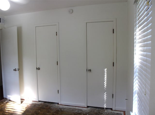 unfurnished bedroom featuring dark hardwood / wood-style flooring and ceiling fan