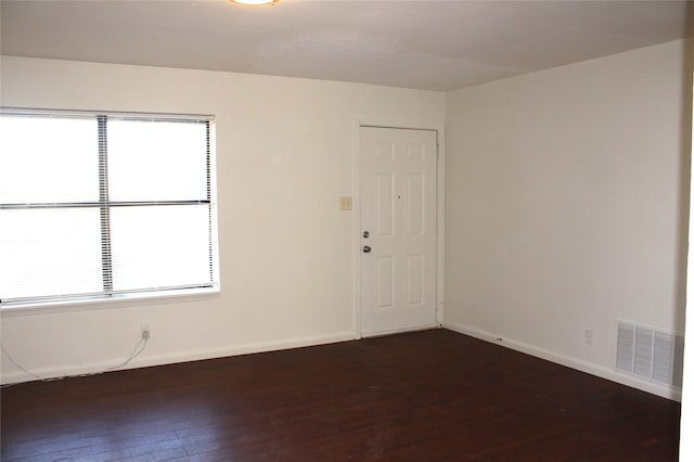 spare room featuring dark hardwood / wood-style floors