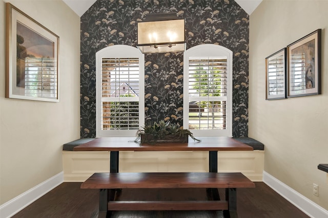 dining room with vaulted ceiling and dark hardwood / wood-style flooring