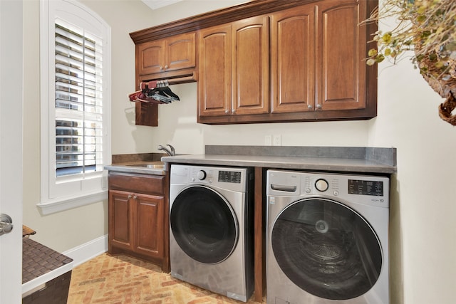 laundry area featuring cabinets, washer and dryer, and sink