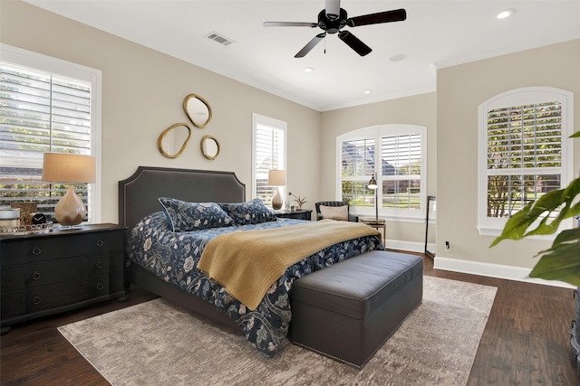 bedroom with ceiling fan, crown molding, and dark hardwood / wood-style flooring