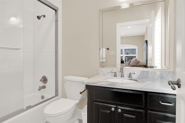 full bathroom with tiled shower / bath combo, vanity, and toilet