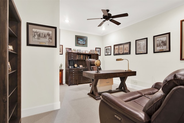 office area with ceiling fan, light colored carpet, and ornamental molding