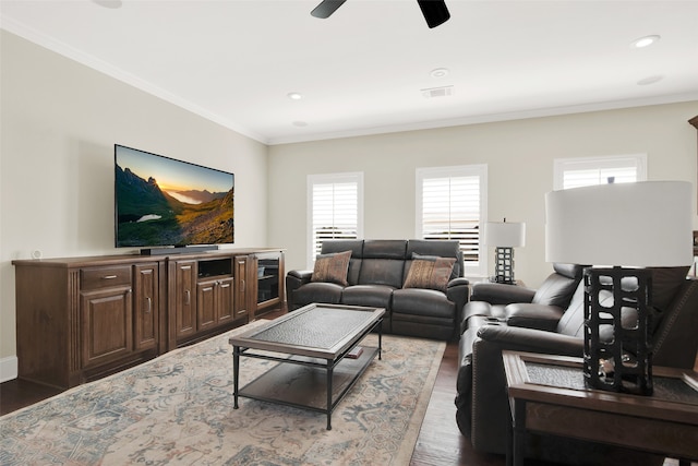 living room with ceiling fan, crown molding, and hardwood / wood-style floors