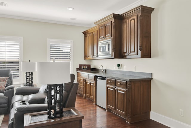 kitchen with dishwashing machine, stainless steel microwave, crown molding, dark hardwood / wood-style floors, and sink