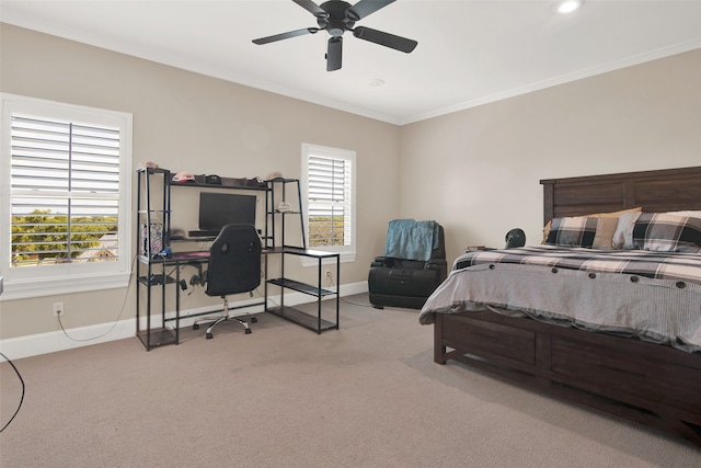 bedroom with multiple windows, crown molding, ceiling fan, and light colored carpet