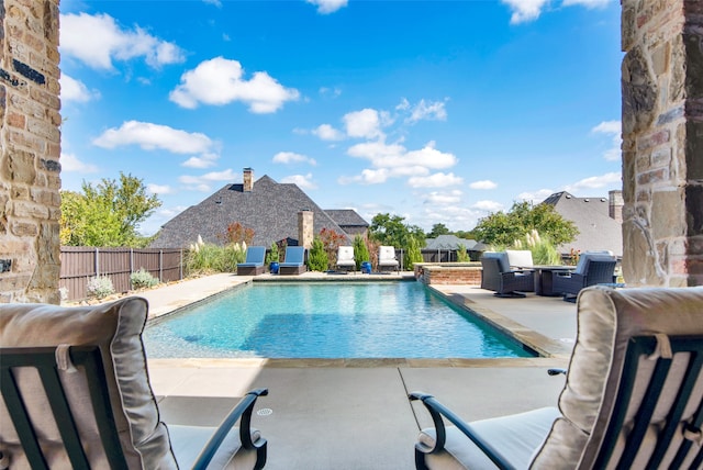 view of pool featuring outdoor lounge area and a patio