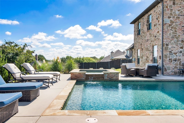 view of swimming pool featuring pool water feature, an in ground hot tub, and a patio area