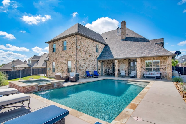 view of pool featuring a patio, an in ground hot tub, a grill, an outdoor hangout area, and pool water feature