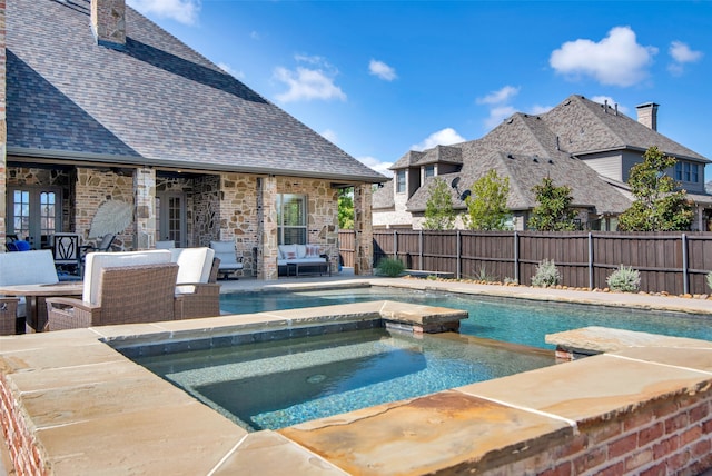 view of pool with a patio, an outdoor living space, an in ground hot tub, and french doors