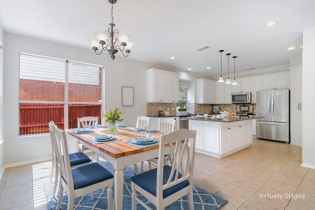 dining room featuring light tile patterned floors and an inviting chandelier