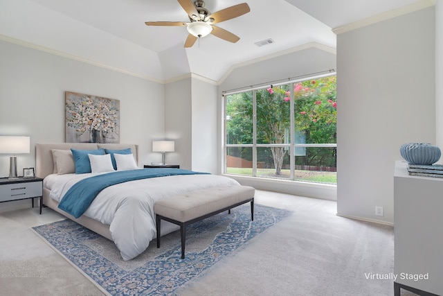 carpeted bedroom with crown molding, multiple windows, lofted ceiling, and ceiling fan