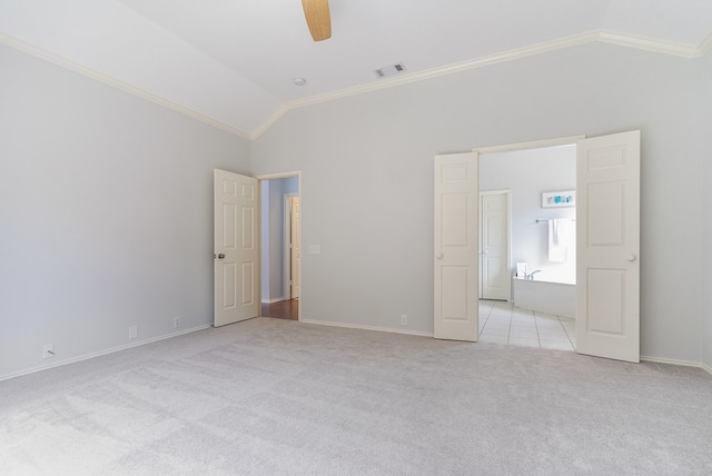 unfurnished room with light colored carpet, vaulted ceiling, ceiling fan, and crown molding