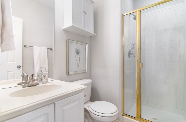 bathroom with vanity, toilet, and walk in shower