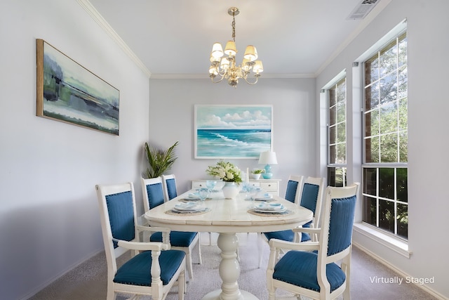 carpeted dining area with a chandelier and ornamental molding