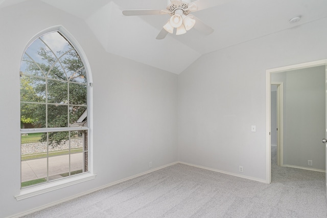 carpeted empty room featuring ceiling fan and lofted ceiling