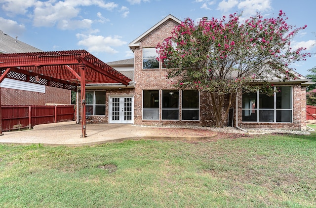 rear view of house with french doors, a pergola, a patio, and a yard