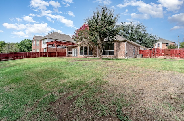 rear view of property with a gazebo and a lawn