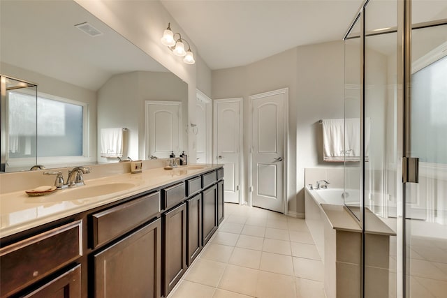 bathroom with plus walk in shower, tile patterned flooring, vanity, and vaulted ceiling