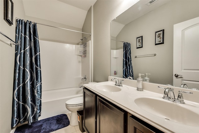 full bathroom with tile patterned floors, shower / bath combo with shower curtain, vanity, and toilet