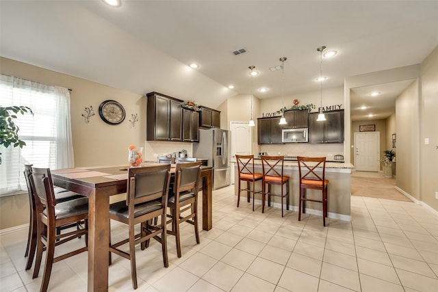 tiled dining area with lofted ceiling