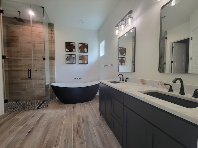 bathroom with vanity, hardwood / wood-style floors, and independent shower and bath