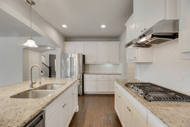 kitchen featuring sink, ventilation hood, appliances with stainless steel finishes, dark hardwood / wood-style floors, and light stone countertops