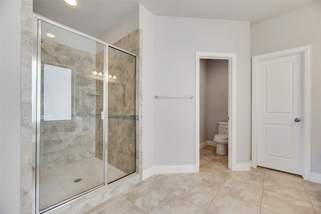 bathroom featuring toilet and an enclosed shower