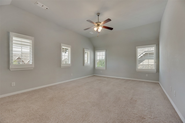 unfurnished room featuring ceiling fan, lofted ceiling, and a healthy amount of sunlight