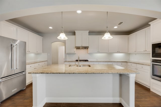 kitchen with pendant lighting, stainless steel appliances, and dark hardwood / wood-style flooring