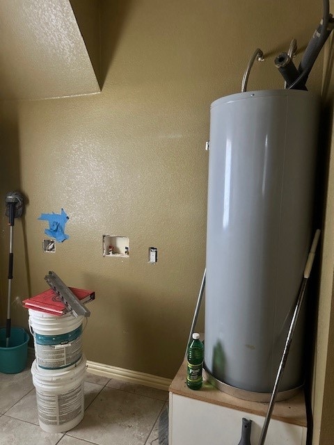 utility room featuring water heater