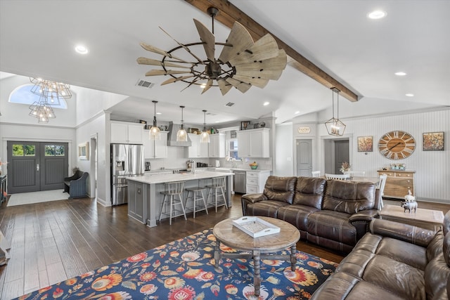 living room featuring lofted ceiling with beams, dark hardwood / wood-style floors, and ceiling fan with notable chandelier