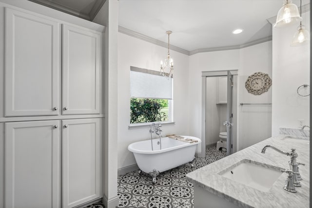 bathroom featuring crown molding, vanity, a notable chandelier, toilet, and a washtub