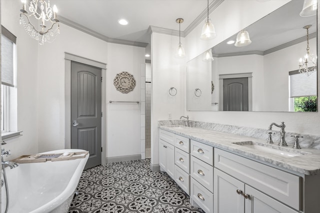 bathroom with an inviting chandelier, vanity, a tub, and ornamental molding