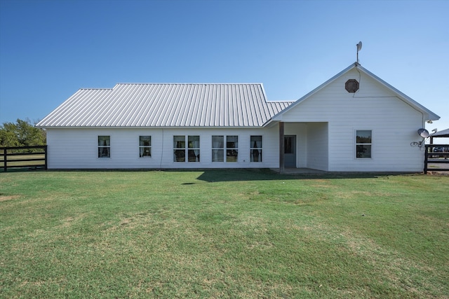 back of property featuring a yard