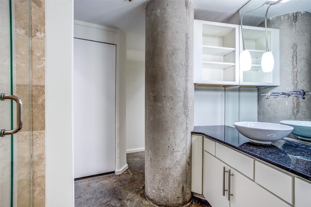 bathroom with walk in shower, vanity, and concrete flooring