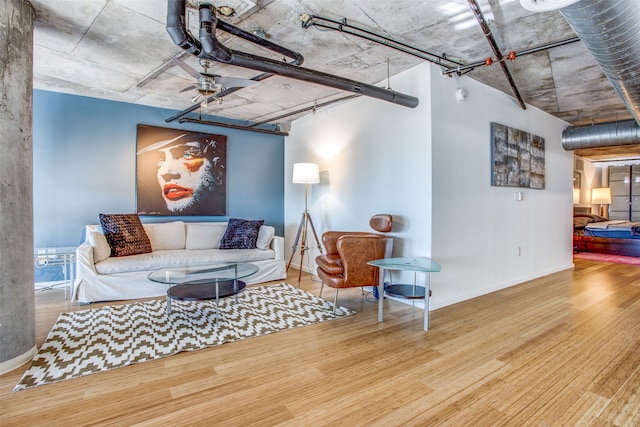 living room featuring wood-type flooring and ceiling fan