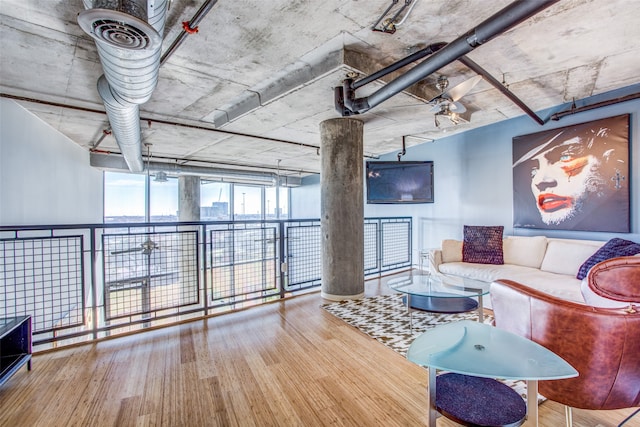 living room with wood-type flooring and a wall of windows