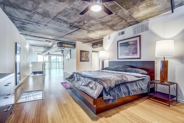 bedroom with ceiling fan and hardwood / wood-style floors