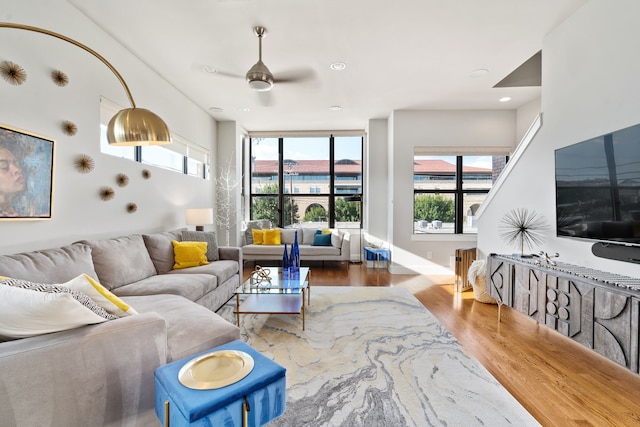 living room with hardwood / wood-style floors, ceiling fan, and plenty of natural light