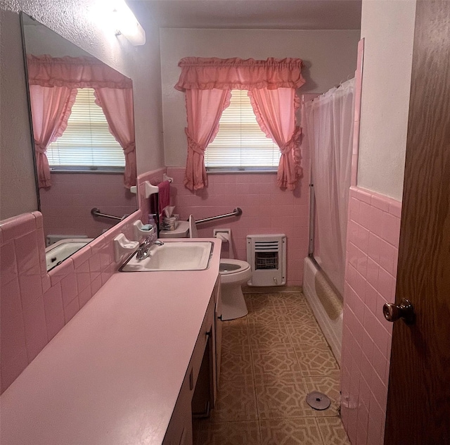 3504 Westfield Ave, Fort Worth, TX 76133 - full bath featuring toilet, vanity, tile walls, heating unit, and shower / tub combo with curtain