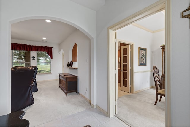 corridor featuring light carpet and crown molding